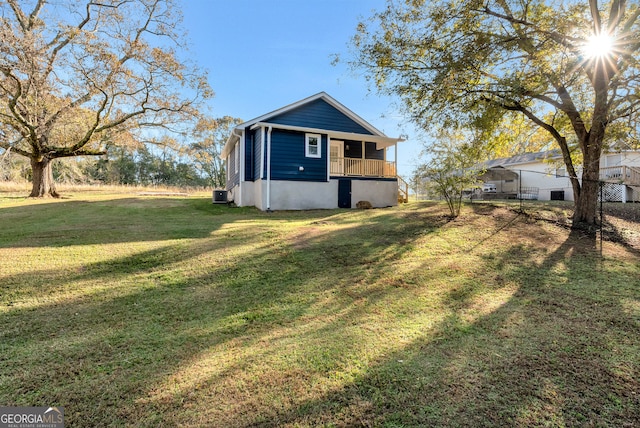 exterior space with a yard and central AC