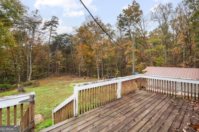 wooden deck featuring a lawn