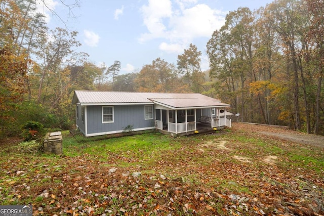 rear view of house featuring a sunroom