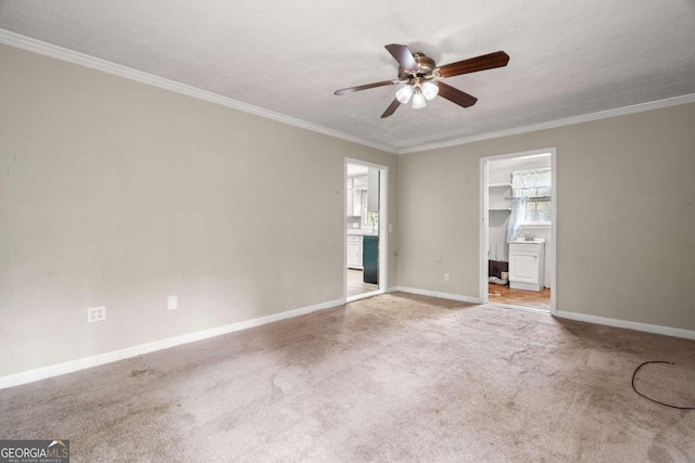 empty room featuring ceiling fan, light colored carpet, a textured ceiling, and ornamental molding