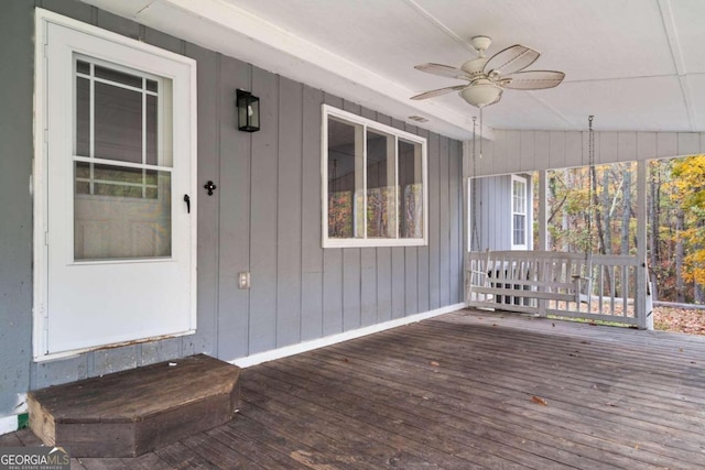 wooden deck featuring ceiling fan