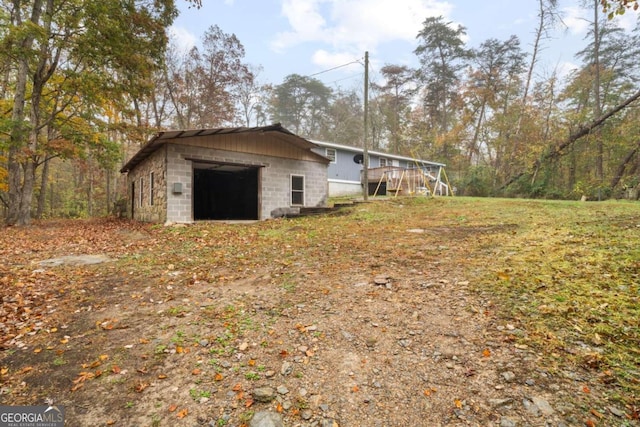 view of side of home featuring a garage and an outdoor structure