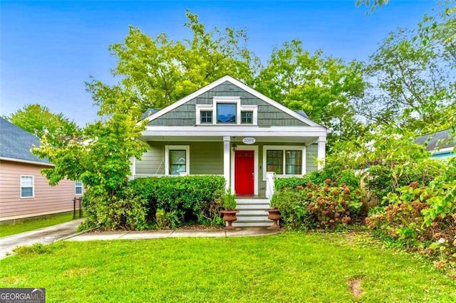 bungalow-style home featuring a front yard