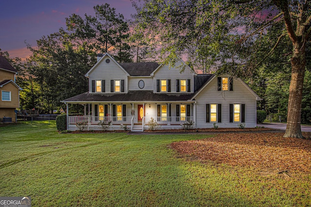 farmhouse featuring a lawn and covered porch