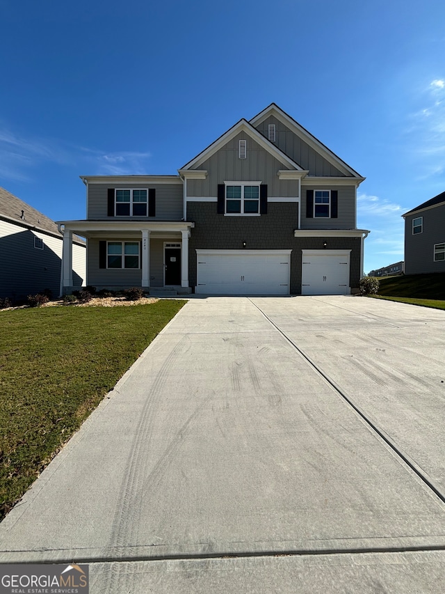 view of front of house featuring a front lawn and a garage