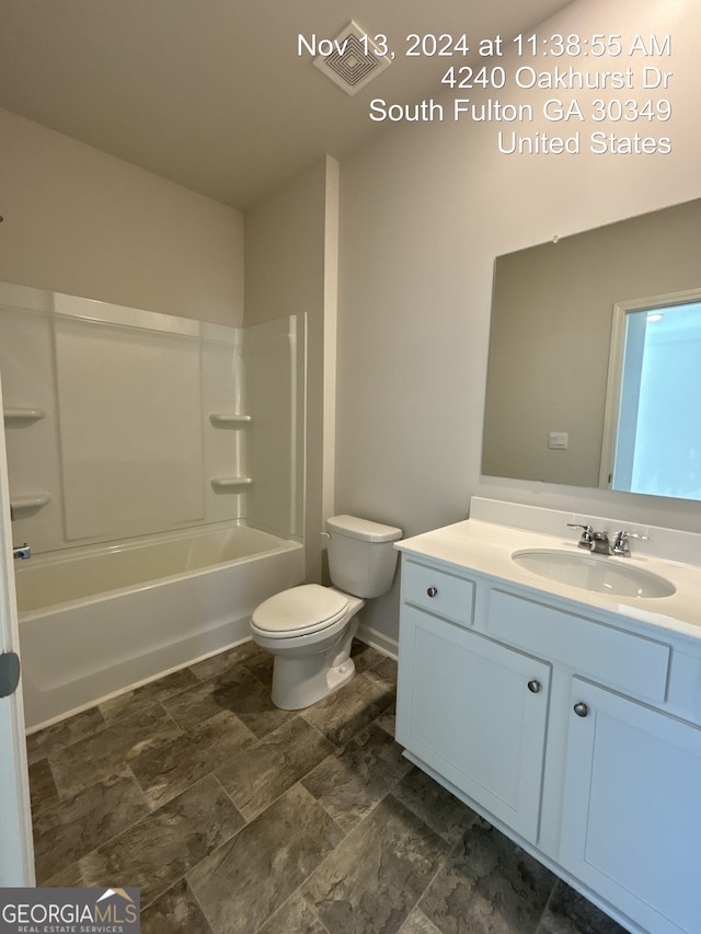 full bathroom with shower / bathing tub combination, vanity, and toilet