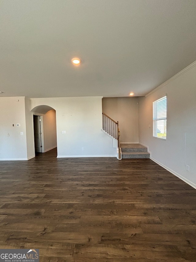 spare room featuring dark hardwood / wood-style floors and ornamental molding