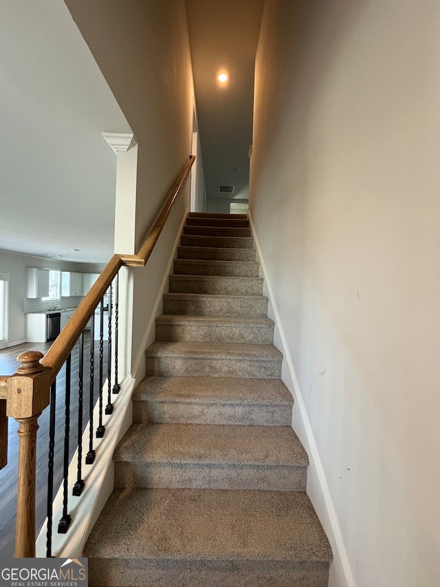 stairway with hardwood / wood-style flooring