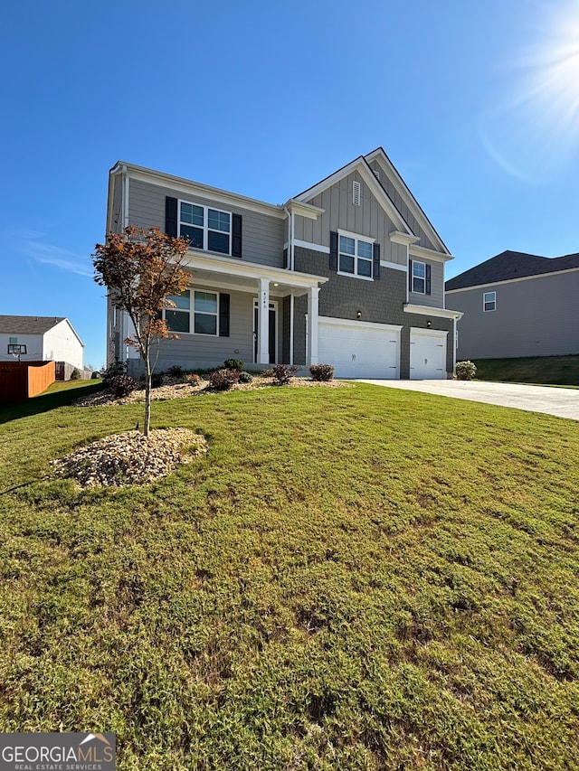 view of front of house featuring a garage and a front lawn