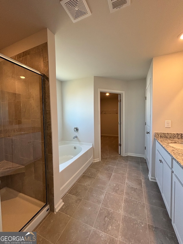 bathroom with separate shower and tub, tile patterned floors, and vanity