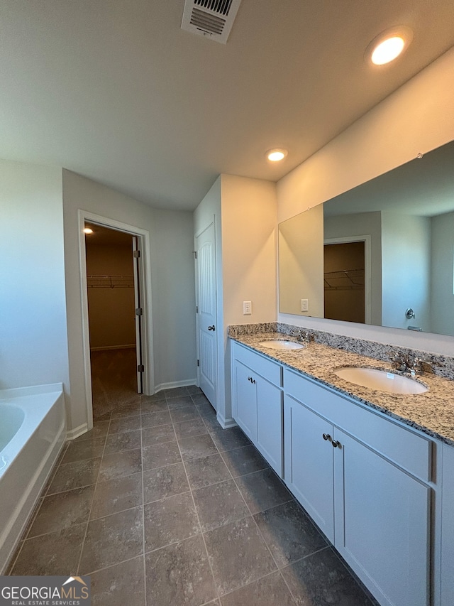 bathroom featuring a tub and vanity