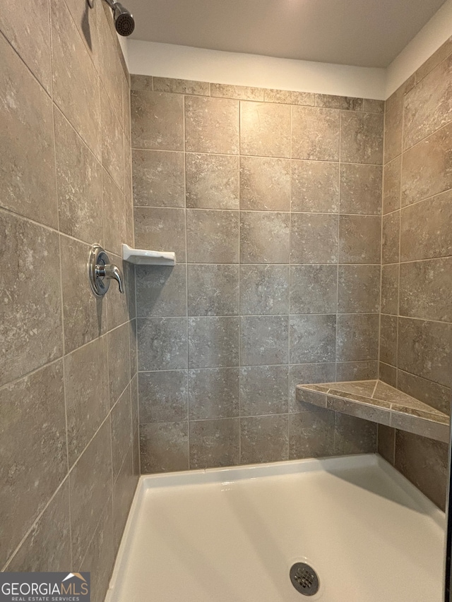 bathroom with tiled shower