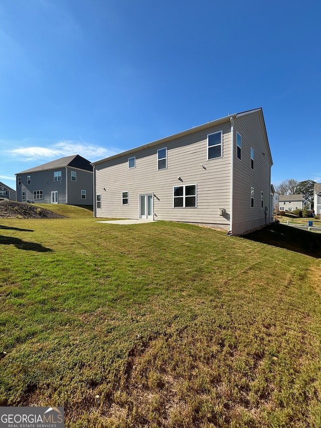 rear view of property with a yard