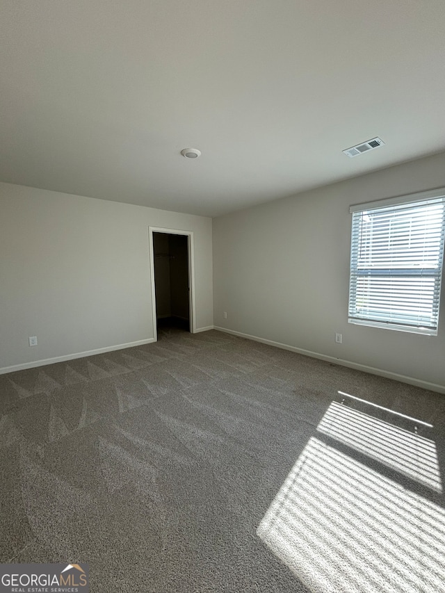 empty room with dark carpet