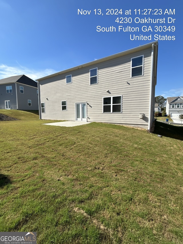 rear view of property with a patio area and a lawn