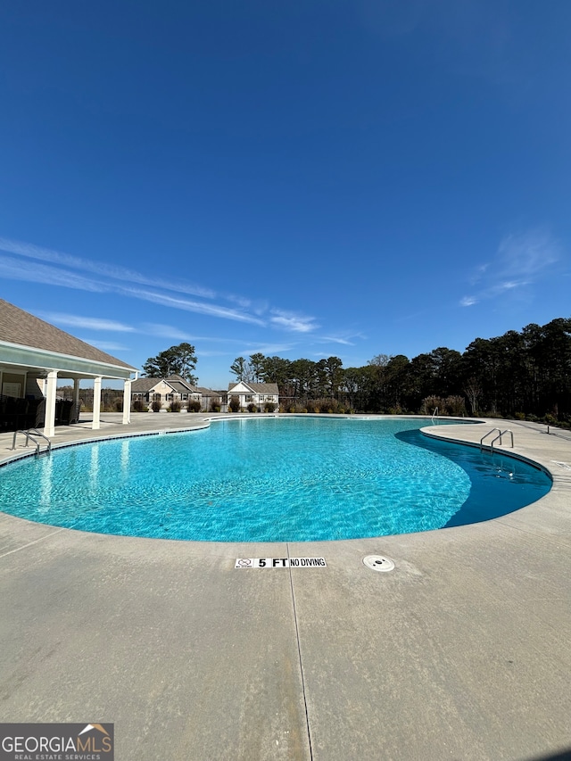 view of swimming pool with a patio