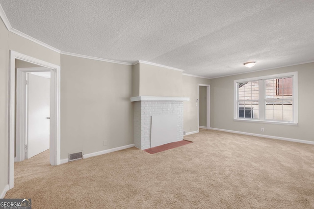 unfurnished living room featuring crown molding, light colored carpet, a textured ceiling, and a brick fireplace