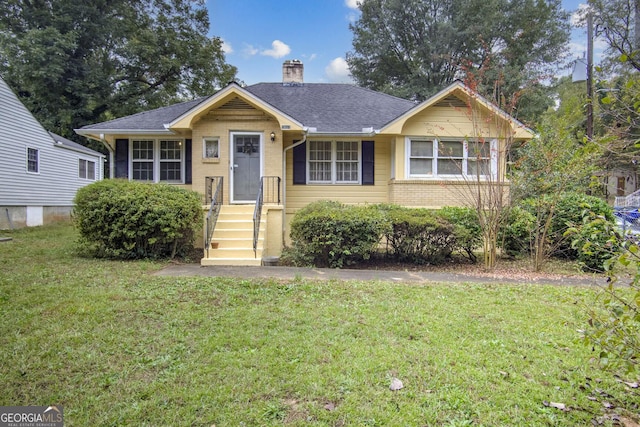 1778 Campbellton Rd SW, Atlanta, GA 30311 - view of front of house with a front yard, a chimney, and brick siding