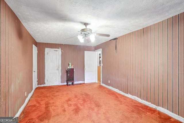 1778 Campbellton Rd SW, Atlanta, GA 30311 - unfurnished room featuring a textured ceiling, a ceiling fan, carpet floors, wooden walls, and baseboards