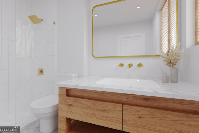 bathroom with tile patterned floors, toilet, vanity, and tiled shower