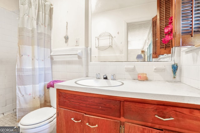 bathroom with walk in shower, vanity, tile walls, and toilet