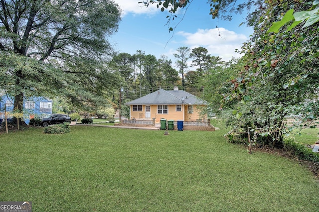 1778 Campbellton Rd SW, Atlanta, GA 30311 - rear view of property featuring a lawn and a patio