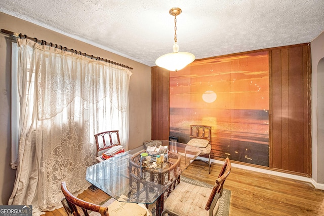 1778 Campbellton Rd SW, Atlanta, GA 30311 - dining space featuring a textured ceiling, wood finished floors, and arched walkways