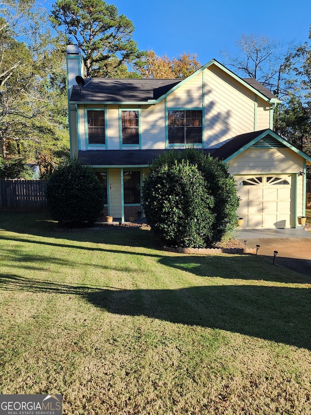 view of front property with a front lawn and a garage