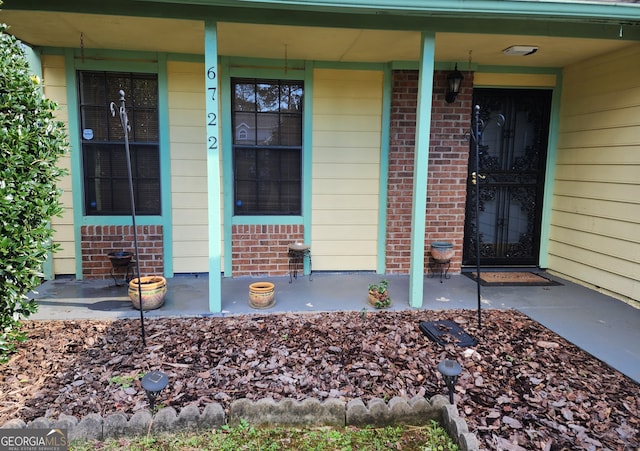 view of exterior entry with a porch