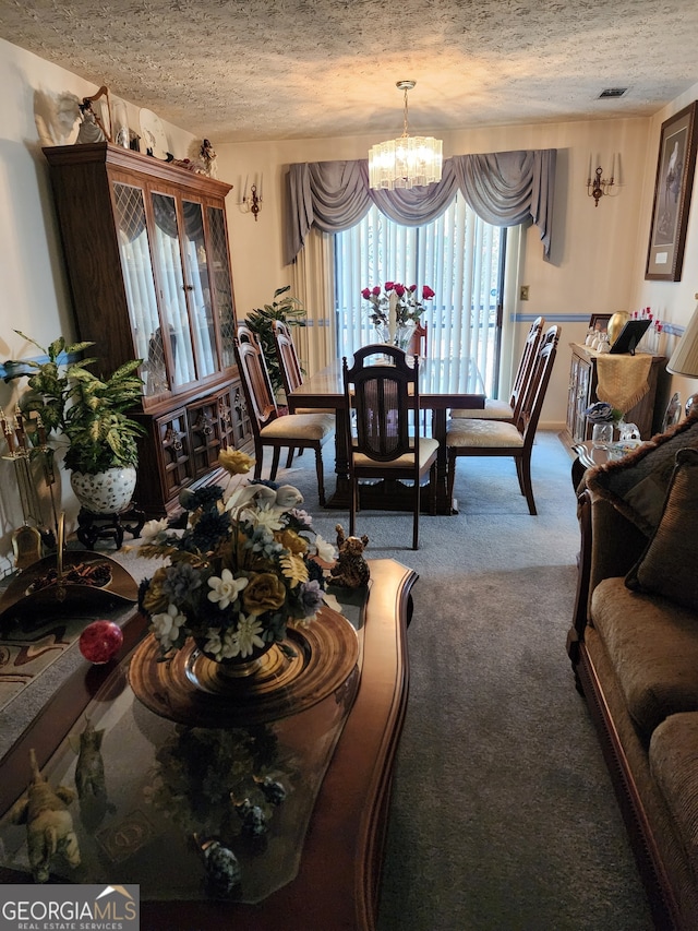 carpeted living room with a textured ceiling and a notable chandelier