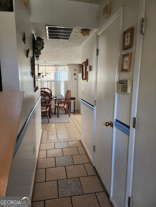 corridor featuring light tile patterned flooring