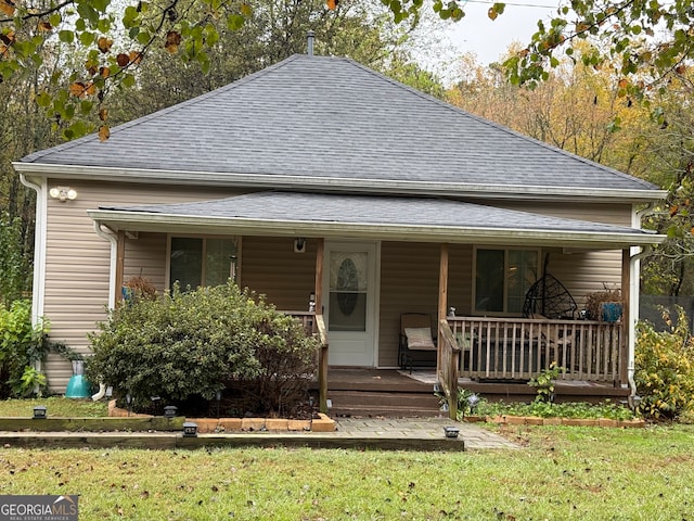 view of front of home with a porch and a front lawn