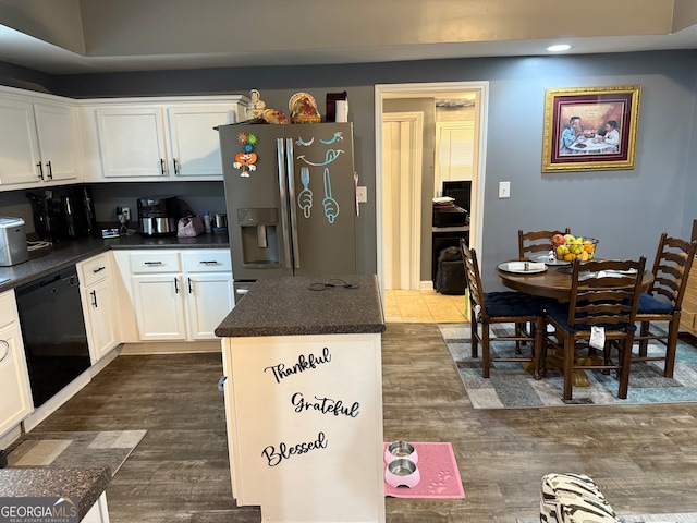 kitchen featuring white cabinetry, a center island, dark wood-type flooring, black dishwasher, and stainless steel refrigerator with ice dispenser