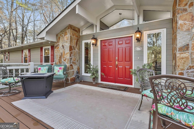 view of exterior entry featuring a deck