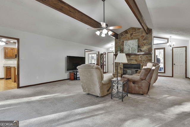 carpeted living room featuring ceiling fan with notable chandelier, lofted ceiling with beams, and a stone fireplace