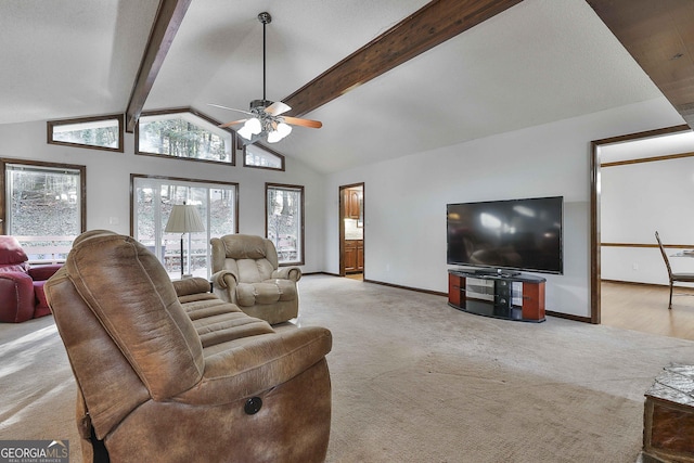 living room with beamed ceiling, light colored carpet, high vaulted ceiling, and ceiling fan