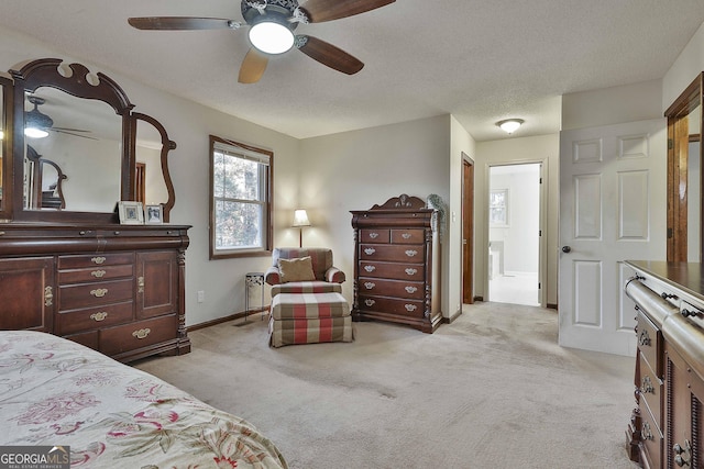 carpeted bedroom featuring ceiling fan and a textured ceiling