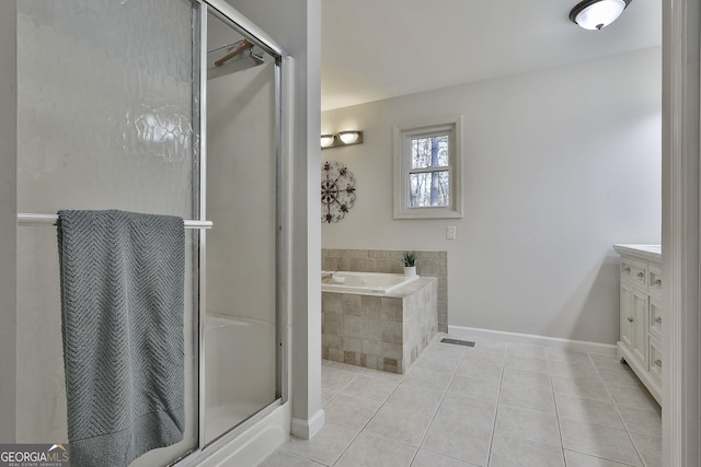 bathroom with tile patterned flooring, vanity, and shower with separate bathtub