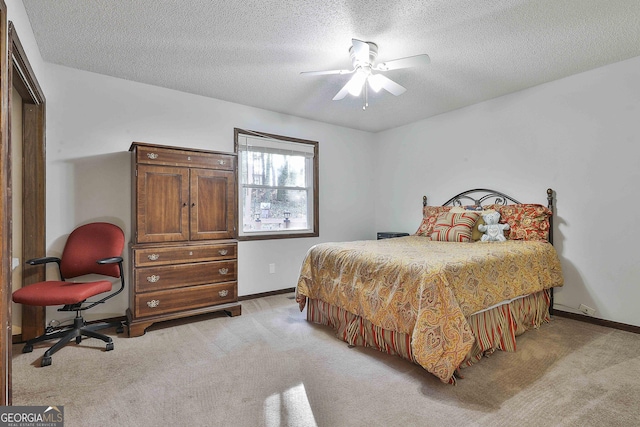 bedroom with ceiling fan, a closet, light carpet, and a textured ceiling