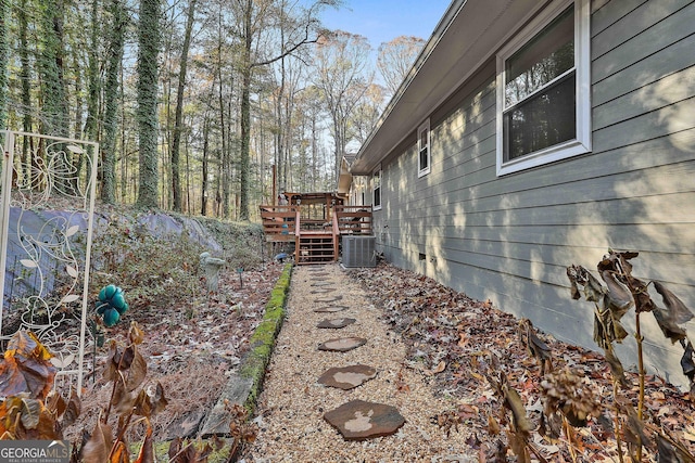 view of yard with a wooden deck and central AC