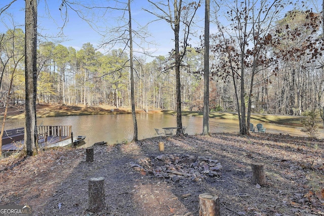 exterior space with a water view and a dock