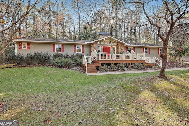 ranch-style home with a front yard and a deck