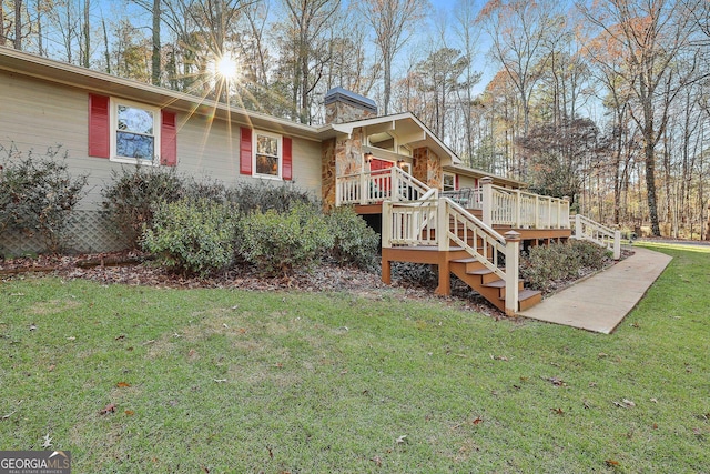 exterior space with a deck and a front lawn