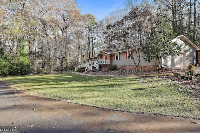 view of front of home with a garage and a front yard