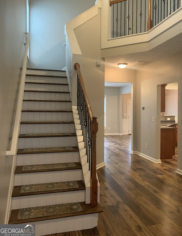 staircase with hardwood / wood-style floors