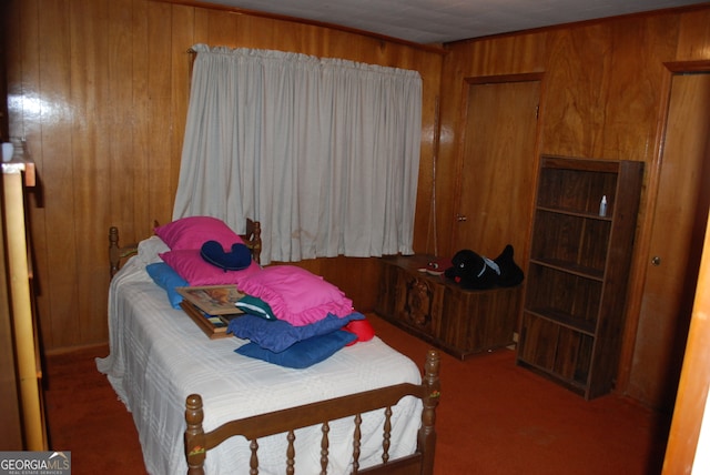 bedroom featuring carpet floors and wooden walls