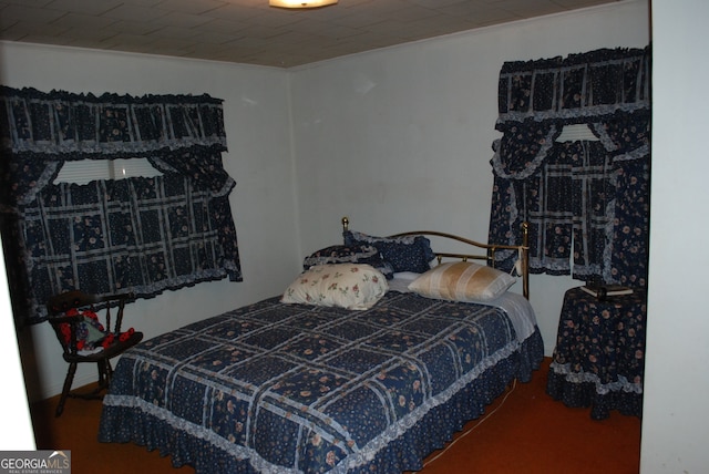 bedroom featuring carpet floors and crown molding