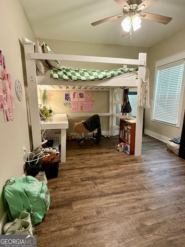 bedroom featuring ceiling fan and dark wood-type flooring