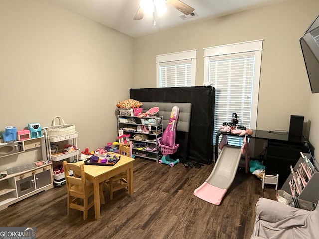 game room with dark hardwood / wood-style flooring and ceiling fan