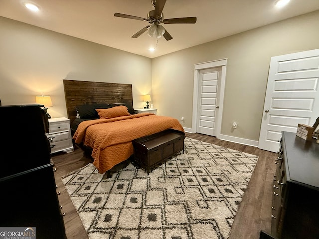 bedroom featuring ceiling fan and dark hardwood / wood-style flooring